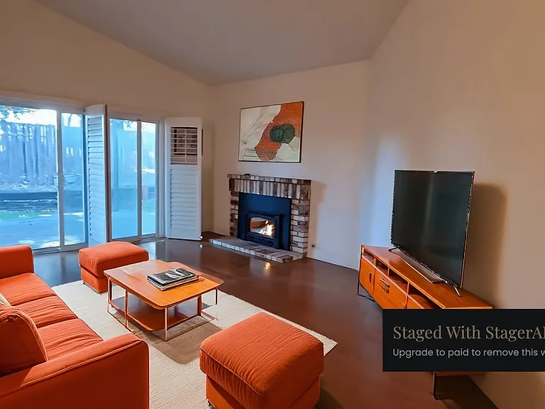 Virtually staged Living room with a fireplace. Sliding doors lead to deck and yard