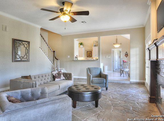 Spacious living open to the kitchen shows out flagstone flooring.