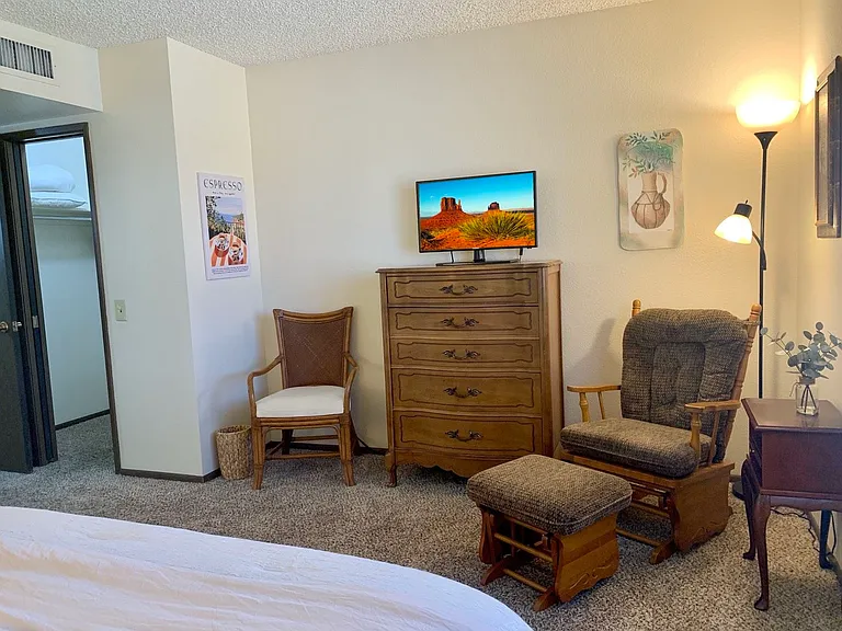 Primary bedroom with flat screen smart TV.