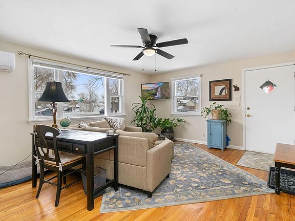 Another view of the living room with the workstation and AC, plus tons of natural light. Also dog/cat friendly!