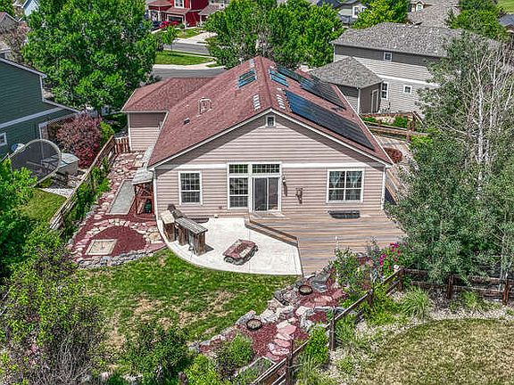 Backyard has expansive deck from front to back of home, hot tub, outdoor TV and surround sound, gas fire pit, built in kitchen, horseshoe pit, garden, and shed for tools