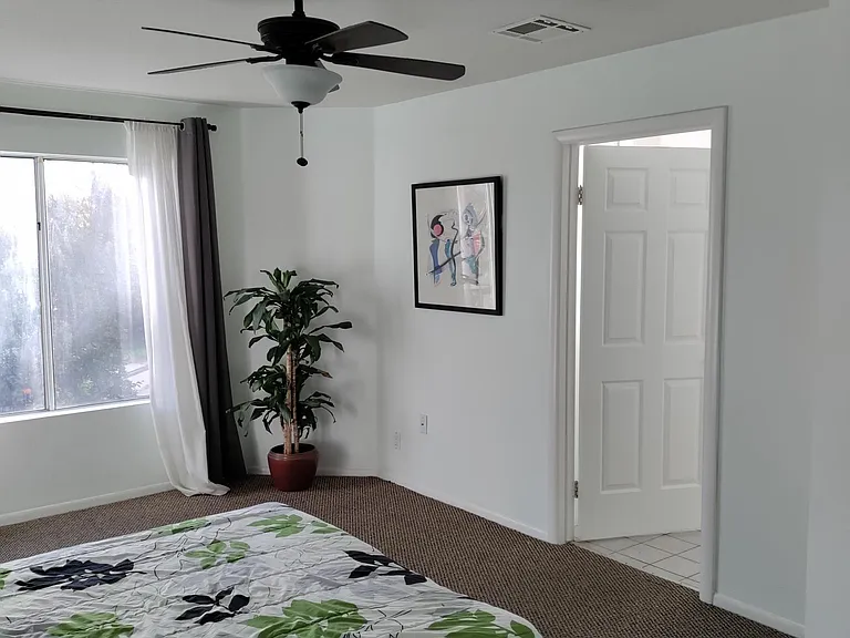 Upstairs front bedroom with attached full bathroom.