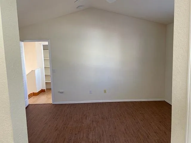 Upper floor primary bedroom with vaulted ceilings