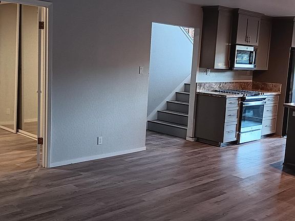 Stairs from entry to open plan living room and kitchen with 
adjoining dining/ office