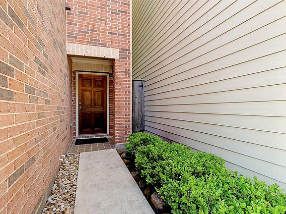 The front door and patio invite you to come inside and have a look!