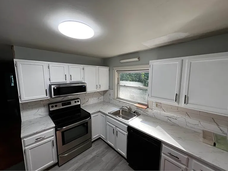 Upgraded new kitchen! Freshly painted cabinets and very soon to be replaced counter top and brand new slim microwave to be mounted! For all your kitchen needs!