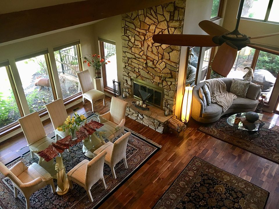 Great room overlooking lake with formal dining room, stone fireplace and beautiful solid hardwood floors.