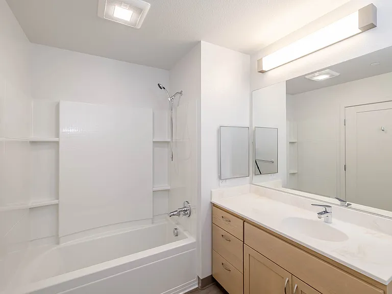 Bathroom B has generous counter space and practical storage options.