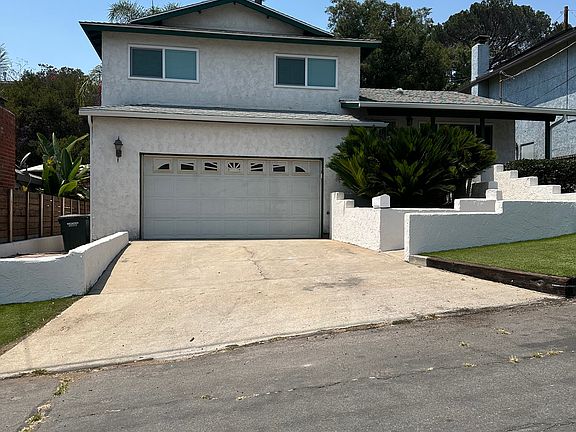 Driveway and 2 car garage Walkway to front door Access to gate to backyard down side of garage