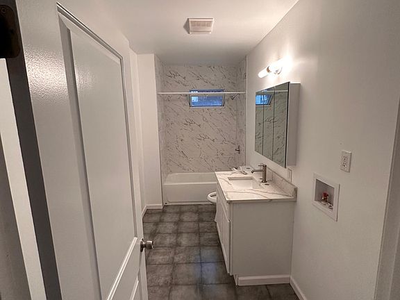 bathroom with marble vanity and above heating