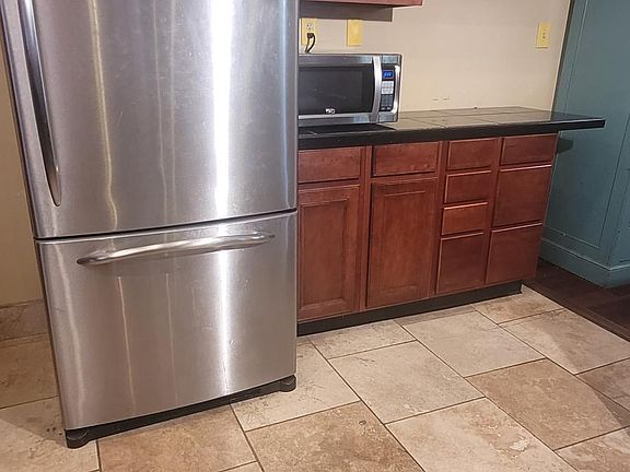 One of GE Profile Suite of appliances. Fridge with bar/prep area