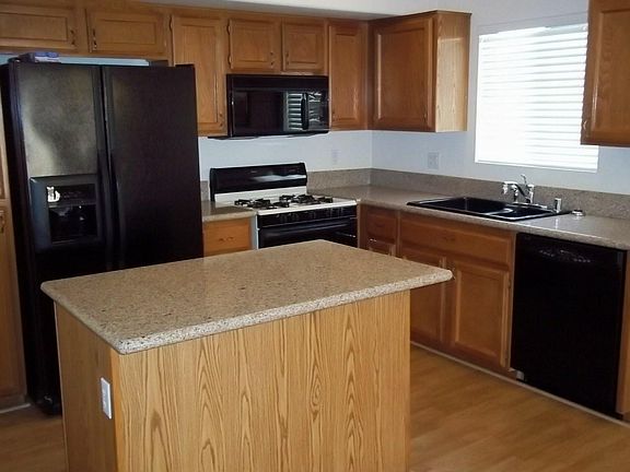 Kitchen with granite counter tops, dishwasher, stove/oven and refrigerator included