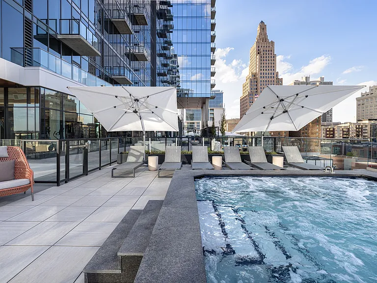 The Expansive Outdoor Terrace with a Hot Tub at Three Light Luxury Apartments