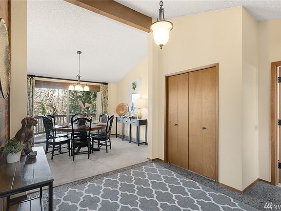 Another view of the foyer with soaring ceiling. To the right you can access the bedrooms, bath, and informal dining area and kitchen.