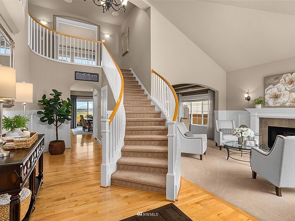Step in to soaring ceilings and an arched staircase.