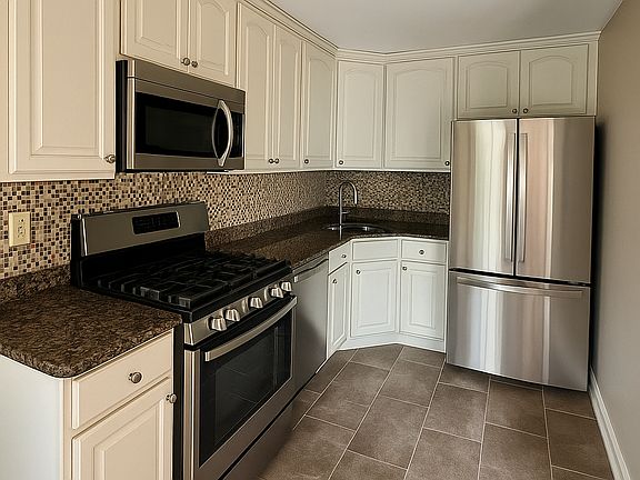 Kitchen includes Stainless Range, Dishwasher, Refrigerator, and Dishwasher