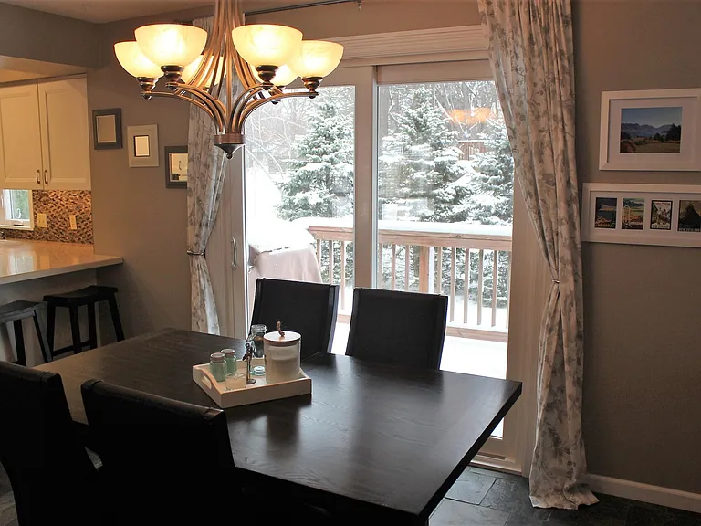 Dining sliding door access to deck and back yard.