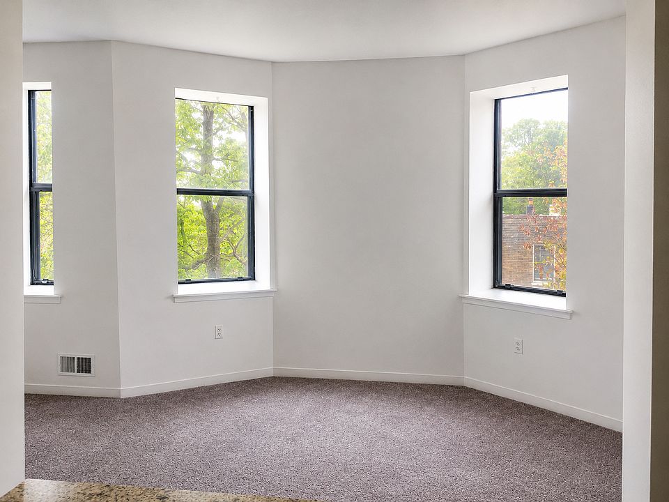 Spacious living room with oversized windows and abundant natural light.