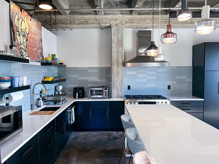 Kitchen storage and custom tile backsplash.