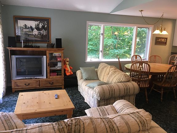 Open concept living room/dining area, leads to kitchen