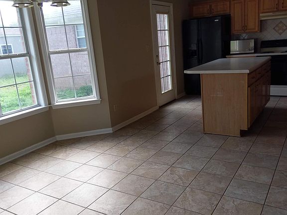 Large eat in kitchen with door to patio and back yard.