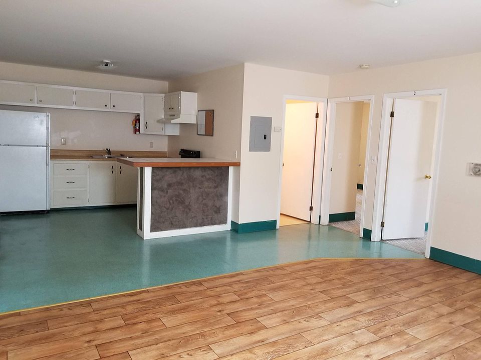 Kitchen includes stove, refrigerator, and breakfast bar.
