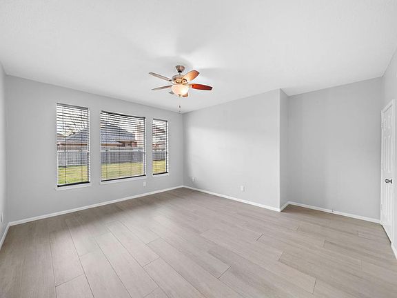 Enormous primary bedroom with walk-in closet and ensuite bathroom.