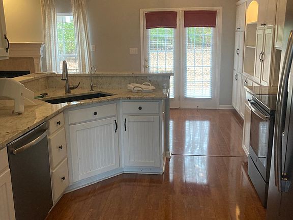 Open concept kitchen looking into breakfast area and family room