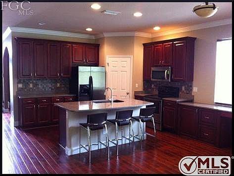 Breathtaking Kitchen with stainless steel appliances and tile backsplash!