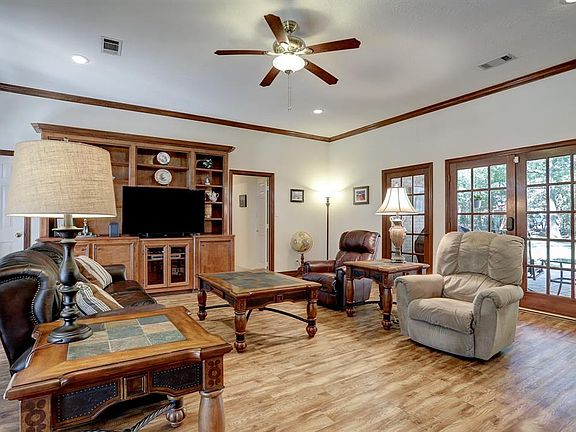 Living room with it's expansive space and walls of windows looking out to the front and back.