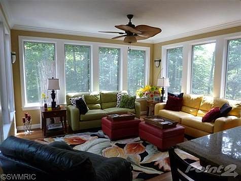 Bright and cheery sun room adjacent to kitchen.