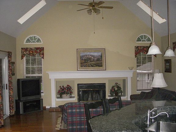 Large Family Room with cathedral ceiling, fireplace and deck access