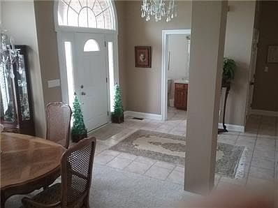 Enter into large tiled entry oval window adorns front door 1/2 ba flows formal dinning room