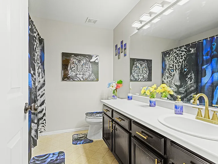 Bright and airy bathroom with a double vanity and a touch of animal print. Perfect for getting ready in the morning.