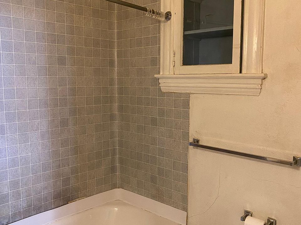 Roomy bathroom eith fun little period medicine cabinet, full size tub.