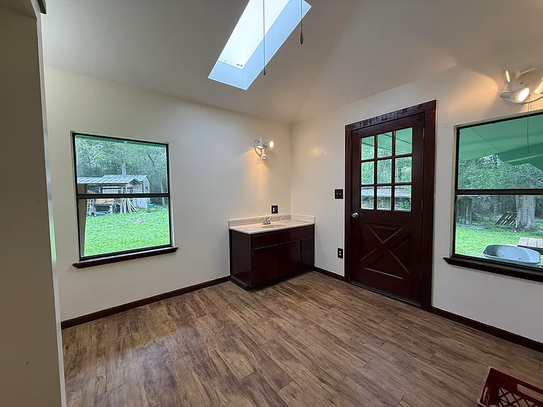 Second bedrom with sksylight and sink.