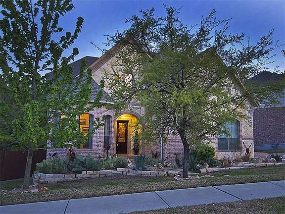 BRICK AND STONE MIX WITH BEAUTIFUL LANDSCAPING TOO!