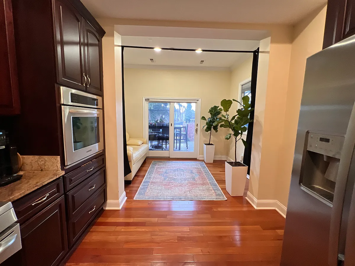 Modern open-concept flow connects the chef's kitchen_featuring dual ovens and dishwashers_to the living area. Highlights include high-end appliances, premium cabinetry, and direct access to the 4,000 sq. ft. Courtyard Lounge via sliding doors. - 126 Adams St NW