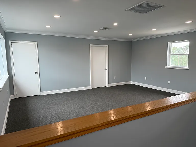 Spacious living area with recessed lighting