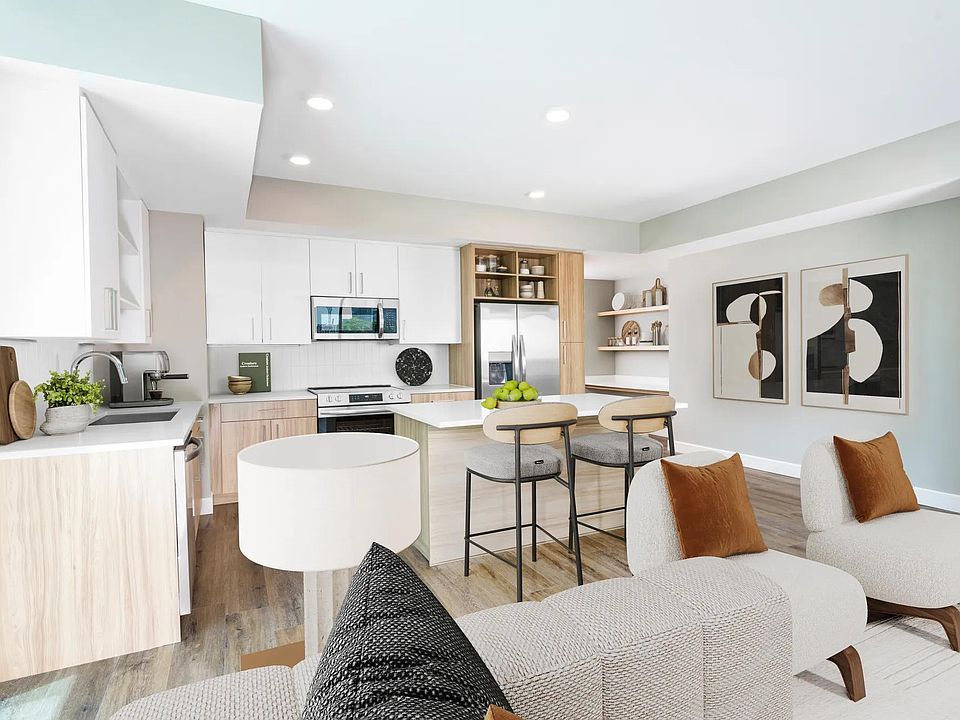 Sleek lines, wood-style flooring, and custom cabinetry_our open-concept kitchens create a clean, contemporary space perfect for everyday living or entertaining.