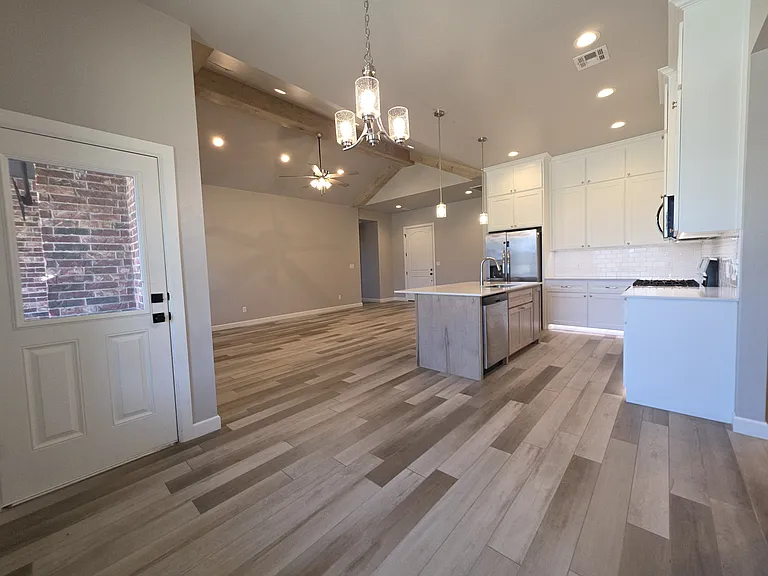 From the corner of the separate dining area you can see the great room & kitchen areas.
The door on the left leads to the back yard & patio.