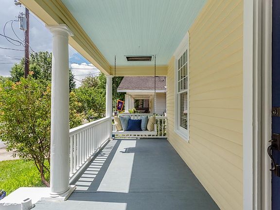 Picture perfect large porch with swing to relax on with a good book and cool drink ...