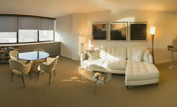 Bright, Open Living & Dining Space 
Spacious open-concept living and dining area featuring large windows for abundant natural light and built-in shelving.