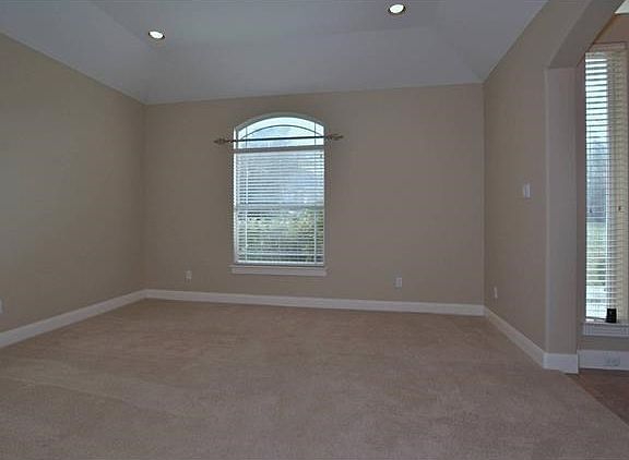 This is the formal living area and is adjoined with the formal dining forming an open floor plan area. It also has canned lighting, which are also found in the formal dining, kitchen, office and family area. The carpet flooring was installed two years ago