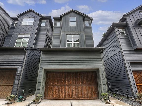 Front of 1034 W. 18th Street with a wood garage door.  This three story home has it all.