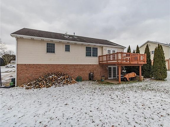 French doors off the kitchen give access to an open air deck & full view of the rear yard, while French doors from the LL family