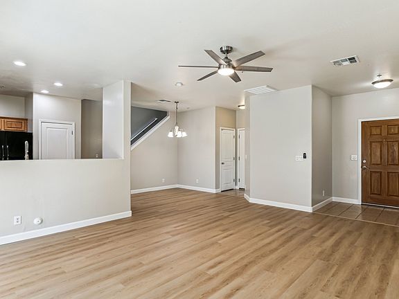 Bottom floor of townhouse with new vinal flooring, kitchen, Storage under the staircase entry way has ceramic tile floor and kitchen floor also