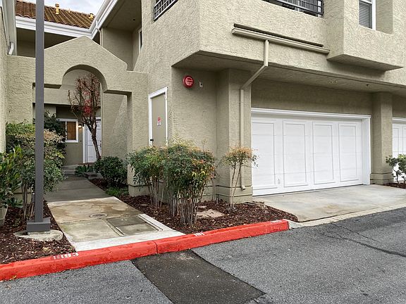 View of the 2 car garage and the pathway to the private unit entrance.