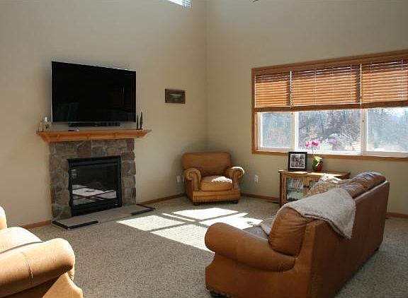 The two story family room has lots of windows and the uppers are remote controlled. There is also a gas fireplace and it looks out over the back yard.