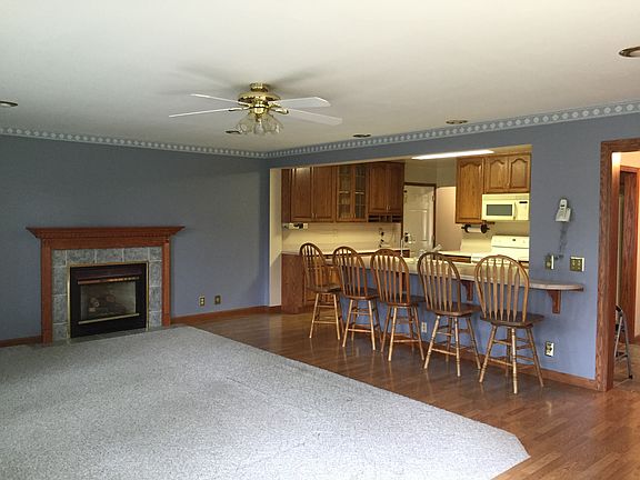 Family room wtih gas fireplace, breakfast bar and kitchen